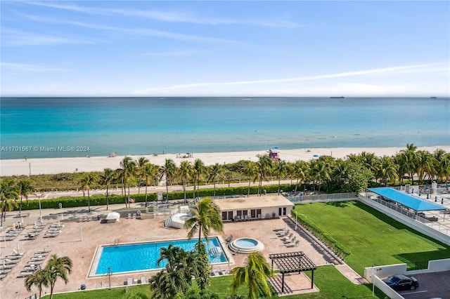 drone / aerial view with a water view and a beach view