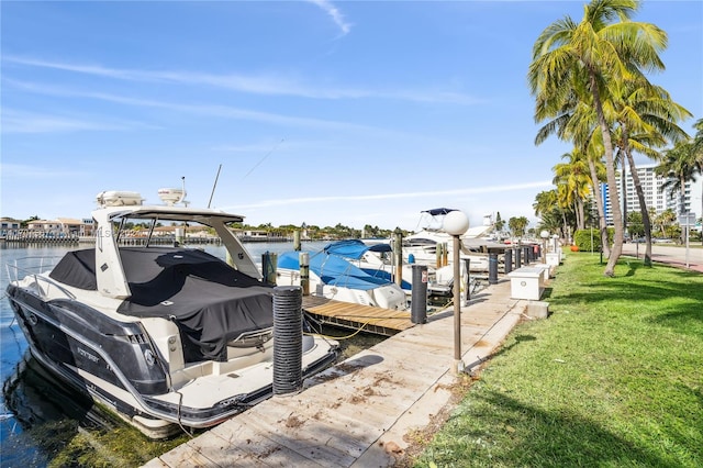 view of dock featuring a yard and a water view