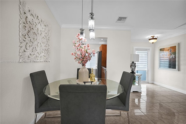 tiled dining area featuring ornamental molding