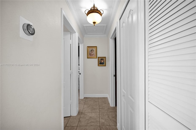 corridor with light tile patterned floors and crown molding