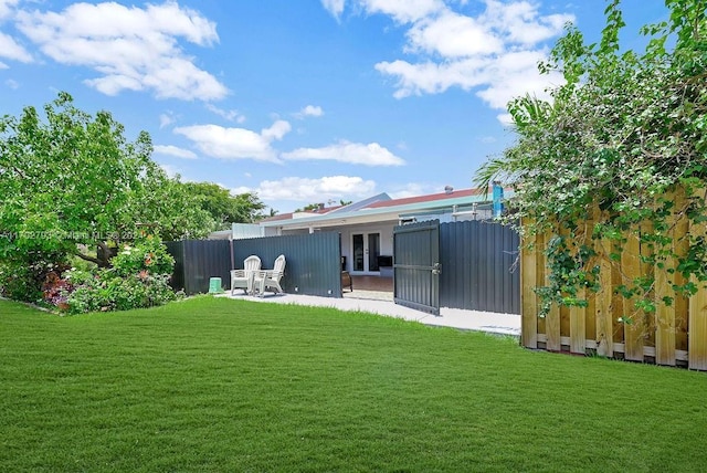 rear view of house featuring a patio and a lawn