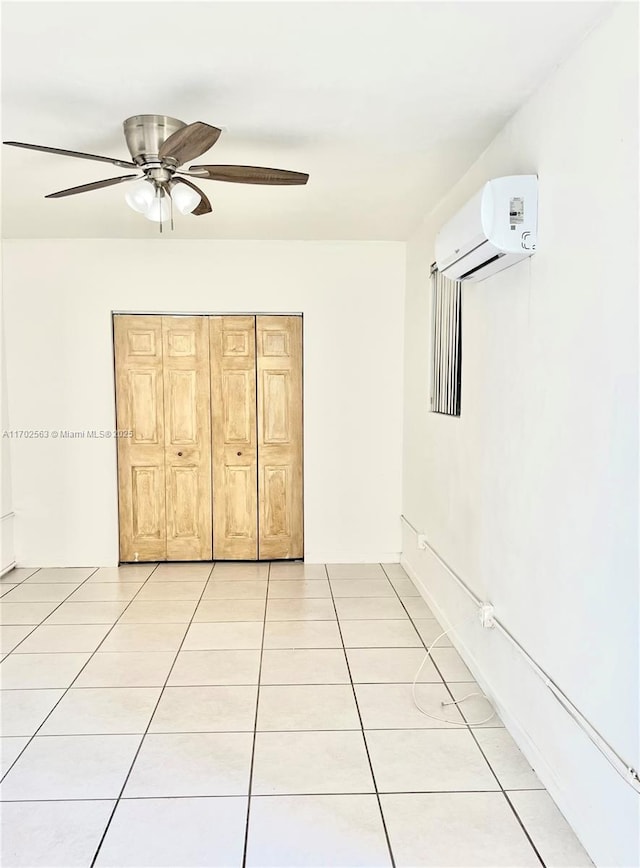 unfurnished bedroom with a wall mounted AC, ceiling fan, and light tile patterned floors