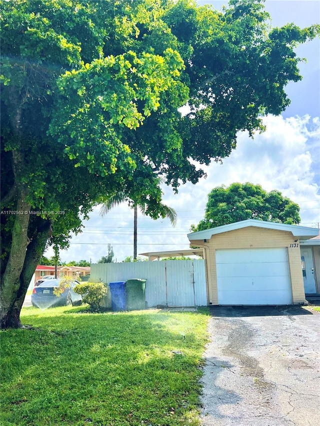 exterior space with a garage and a front lawn