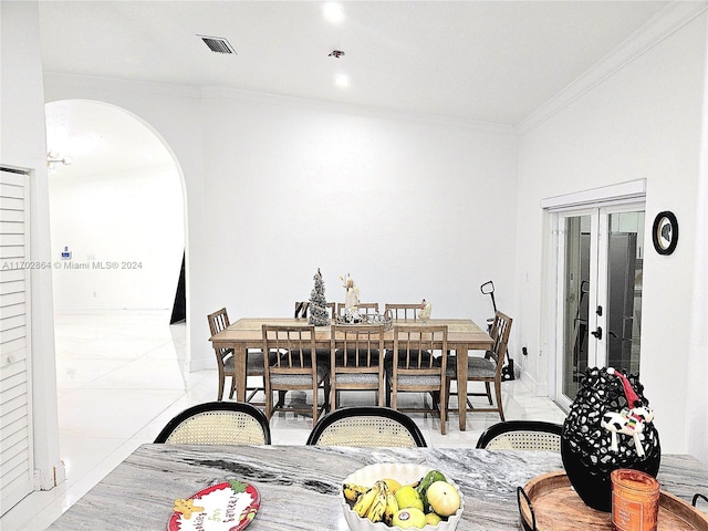 dining room featuring french doors and crown molding