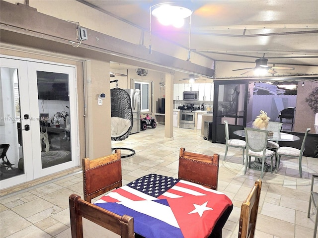 dining room featuring french doors, lofted ceiling with beams, and ceiling fan