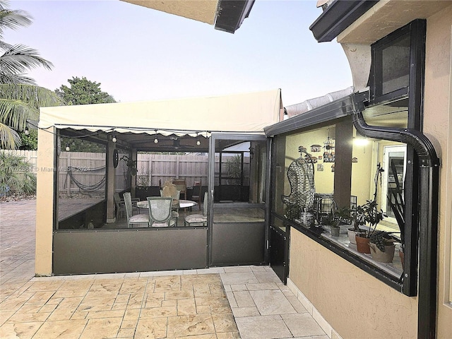 patio terrace at dusk featuring a gazebo and a sunroom