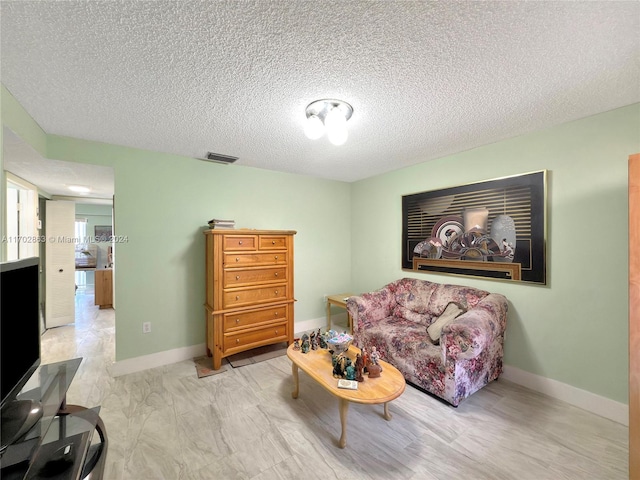 living room featuring a textured ceiling