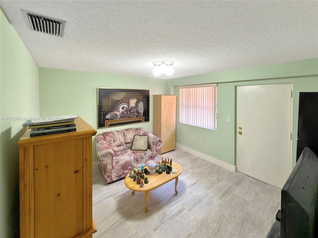 living area with a textured ceiling