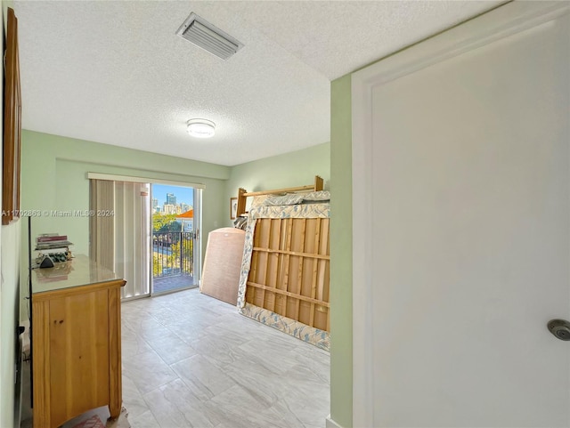 hallway with a textured ceiling