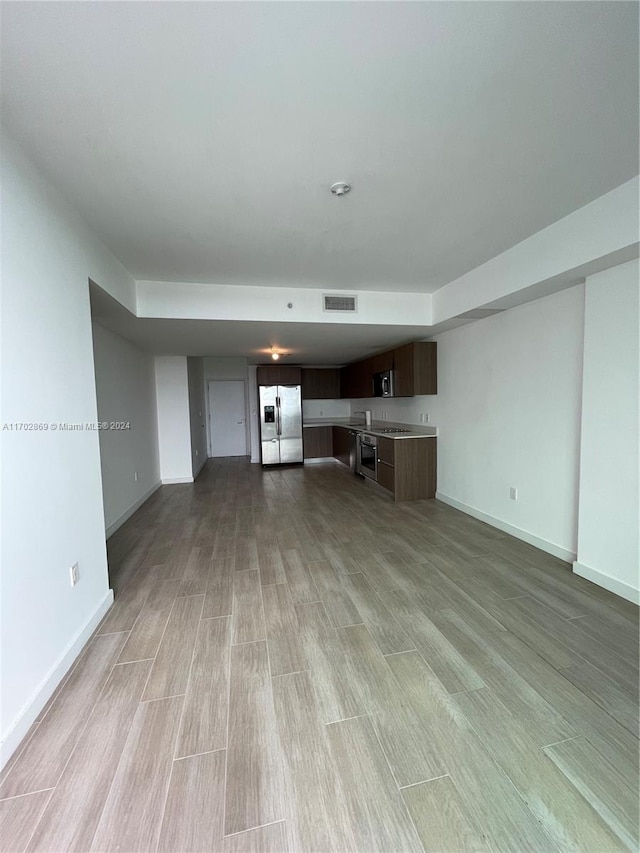 unfurnished living room with light wood-type flooring