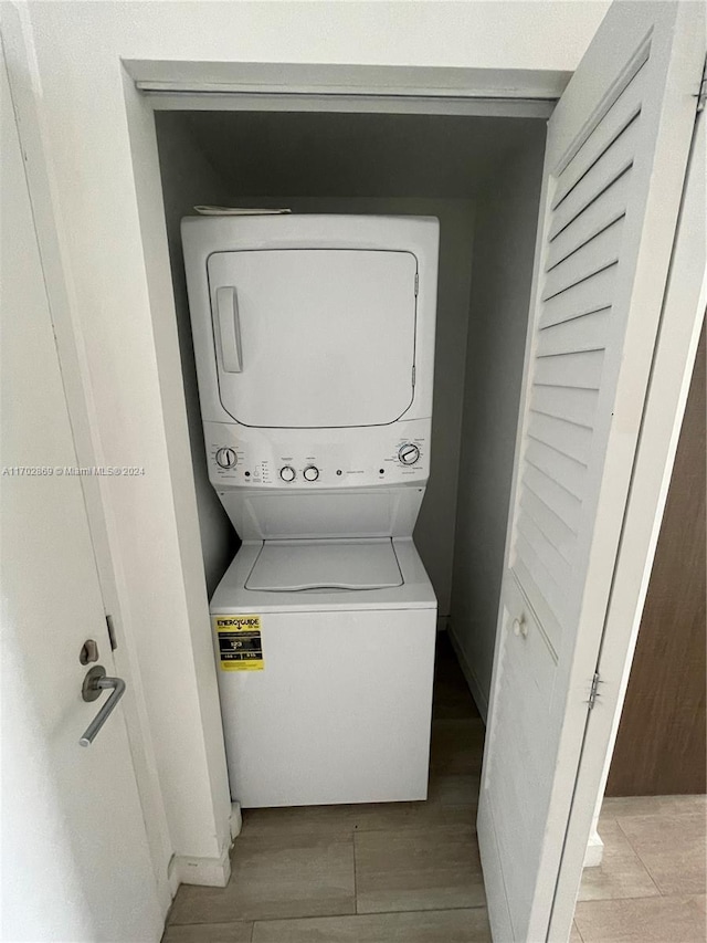 laundry room with stacked washing maching and dryer