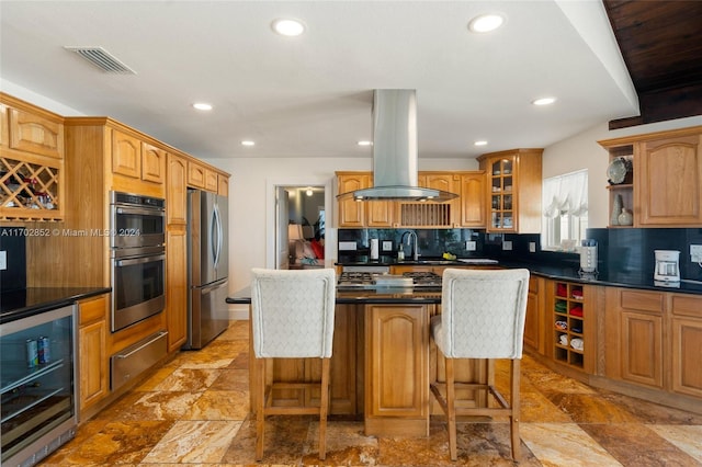 kitchen with a breakfast bar, a kitchen island, stainless steel appliances, and island range hood