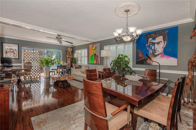 dining space featuring a textured ceiling, ceiling fan with notable chandelier, wood-type flooring, and crown molding