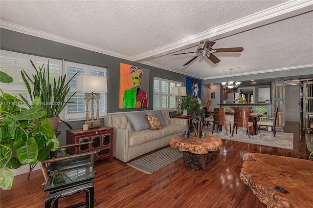 living room with ceiling fan with notable chandelier, hardwood / wood-style floors, a textured ceiling, and crown molding