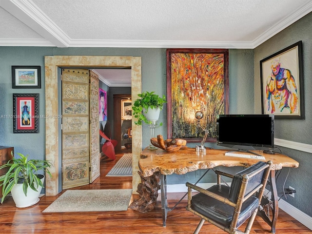 office space featuring ornamental molding, a textured ceiling, and hardwood / wood-style flooring