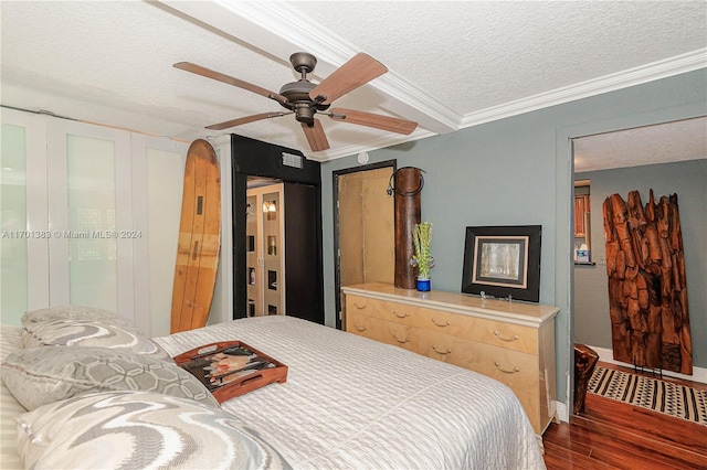 bedroom featuring a textured ceiling, dark hardwood / wood-style flooring, ceiling fan, and ornamental molding