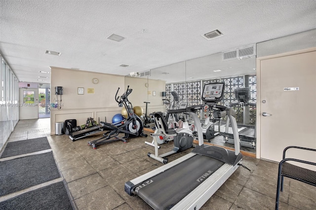 gym featuring a textured ceiling