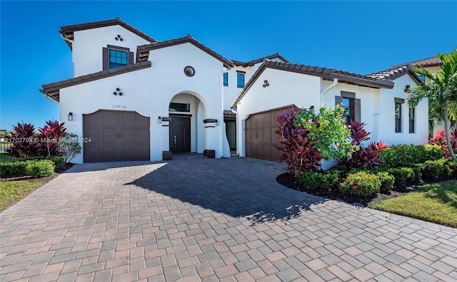 mediterranean / spanish-style house with a garage