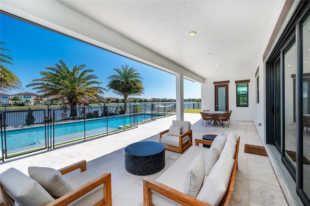 view of patio with a fenced in pool, an outdoor hangout area, and a water view