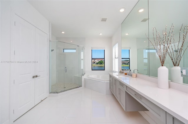 bathroom with tile patterned floors, vanity, and independent shower and bath