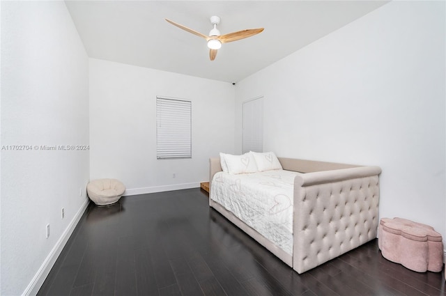 bedroom with dark hardwood / wood-style floors and ceiling fan