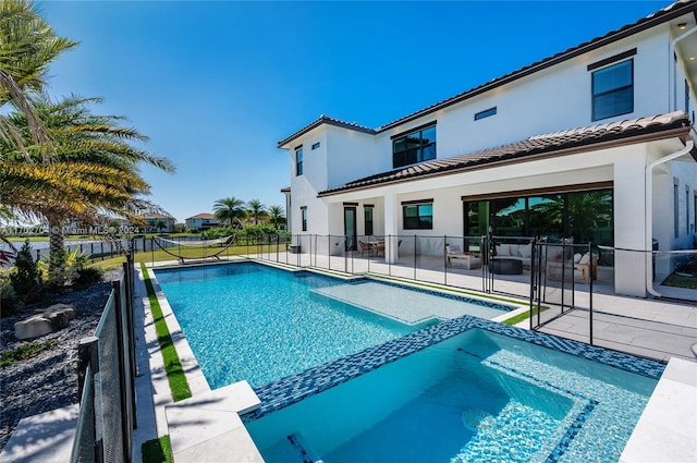 view of pool with an in ground hot tub and a patio area