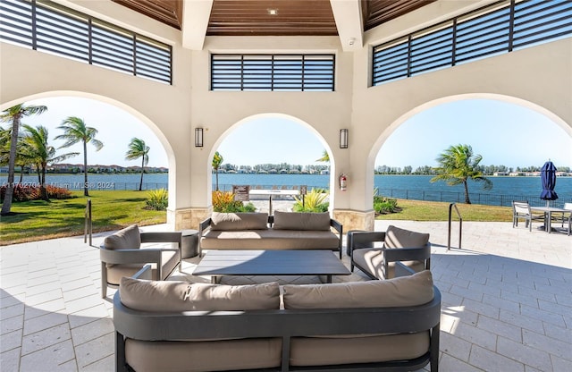 view of patio with an outdoor living space and a water view