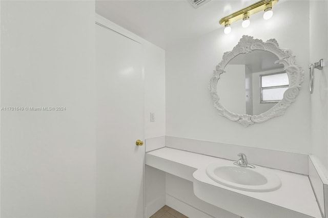 bathroom with tile patterned flooring and vanity