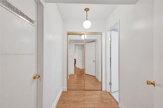 hallway with light hardwood / wood-style floors