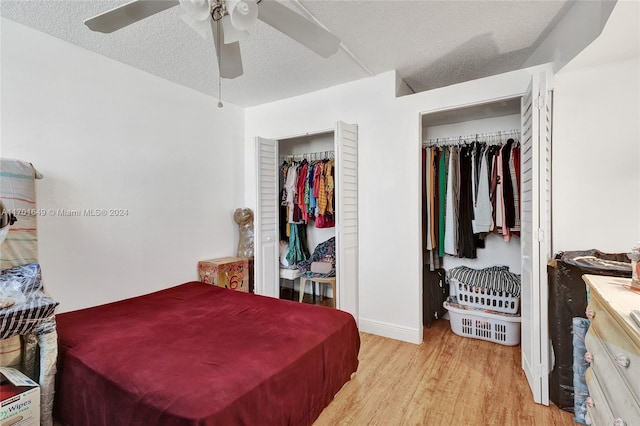 bedroom featuring a textured ceiling, a closet, light hardwood / wood-style flooring, and ceiling fan