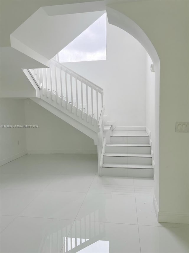 stairs featuring tile patterned flooring