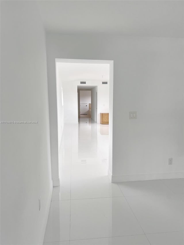 hallway featuring light tile patterned floors