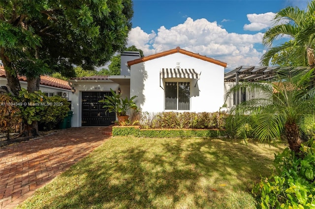 mediterranean / spanish home with a front yard