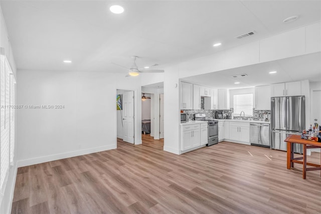 kitchen with white cabinetry, light hardwood / wood-style flooring, ceiling fan, and appliances with stainless steel finishes