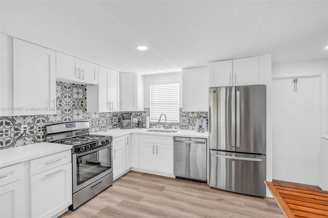 kitchen with sink, white cabinetry, and stainless steel appliances