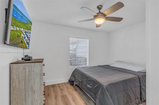 bedroom with ceiling fan and hardwood / wood-style flooring