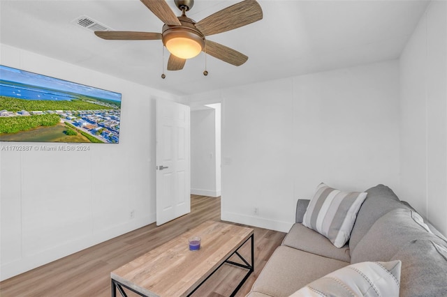 living room featuring hardwood / wood-style flooring and ceiling fan