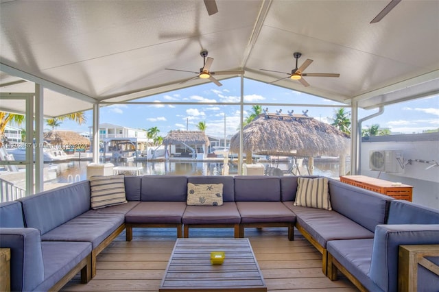 sunroom featuring a water view, a wealth of natural light, and lofted ceiling