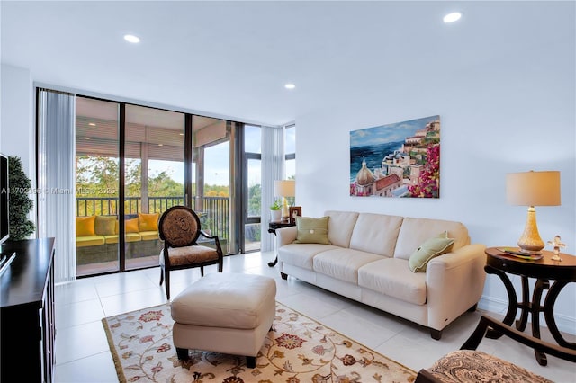 living room with floor to ceiling windows and light tile patterned floors