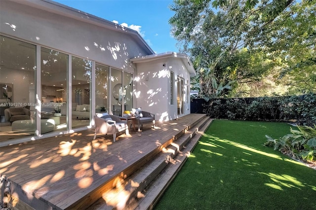 wooden deck featuring a lawn