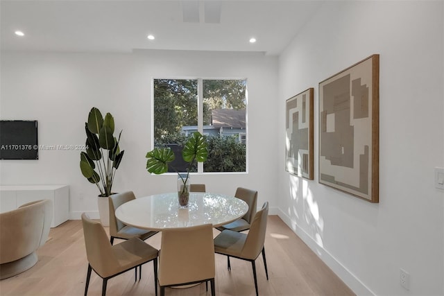 dining space with light hardwood / wood-style floors