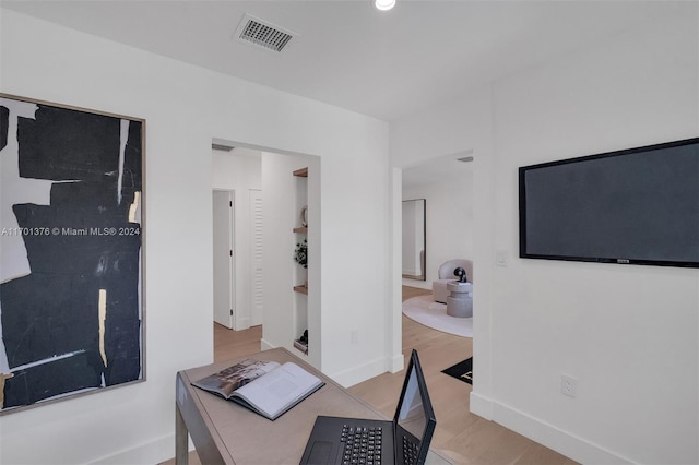 office with light hardwood / wood-style floors