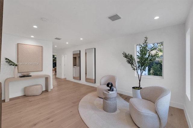 sitting room with light hardwood / wood-style flooring