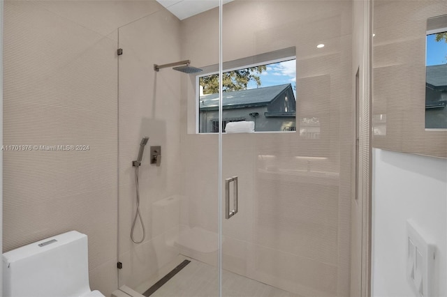 bathroom with toilet and walk in shower