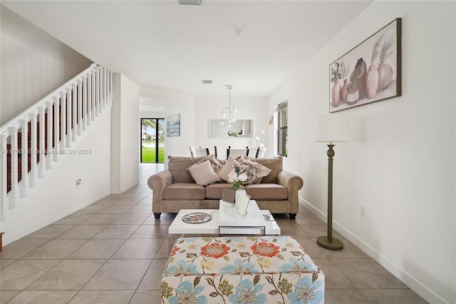 living room featuring light tile patterned floors and a notable chandelier