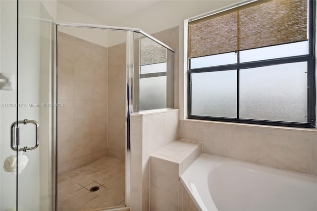 bathroom with shower with separate bathtub