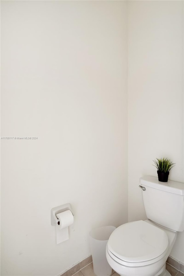 bathroom featuring tile patterned flooring and toilet