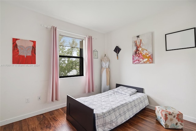 bedroom with dark hardwood / wood-style flooring