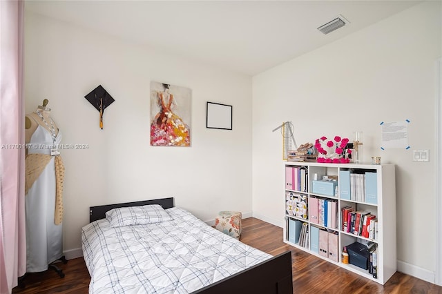 bedroom with dark wood-type flooring