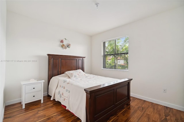 bedroom with dark hardwood / wood-style floors